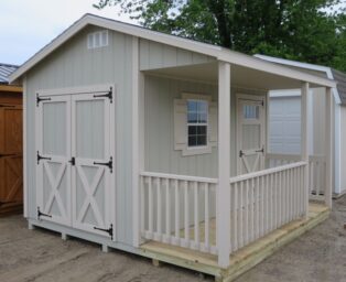One of our cabin sheds for sale in Dublin OH - Light taupe siding and light peach framed single and double doors and windows -