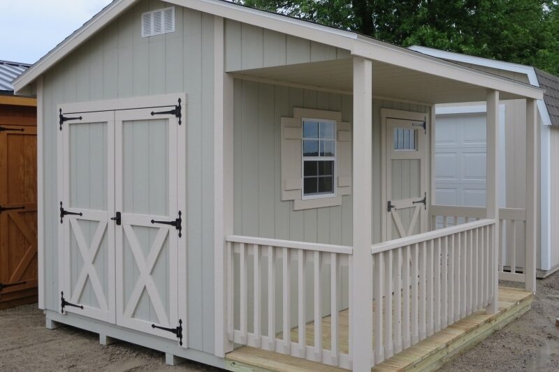 One of our cabin sheds for sale in Dublin OH - Light taupe siding and light peach framed single and double doors and windows -