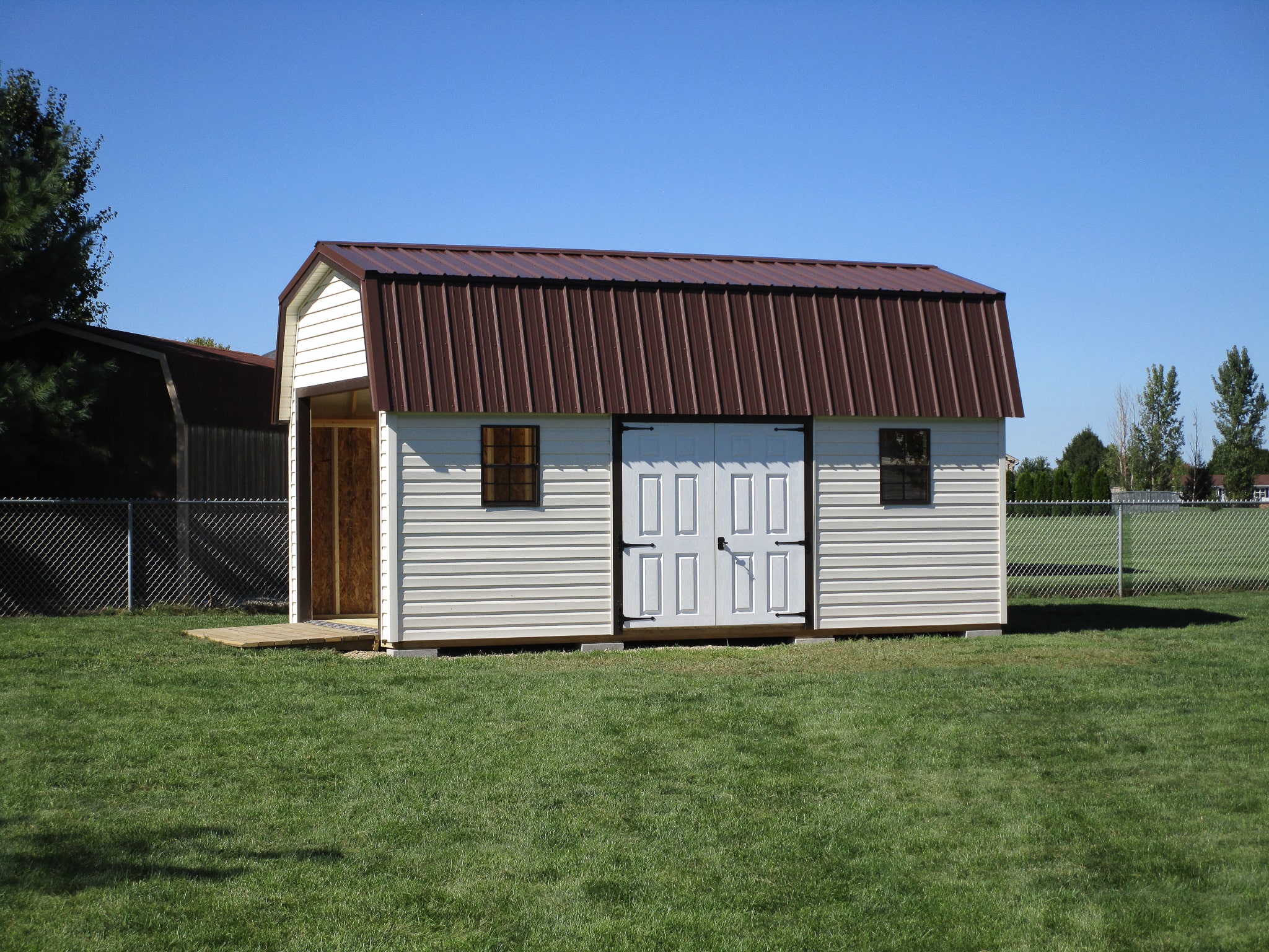 a beige shed with a brown metal roof in Ohio